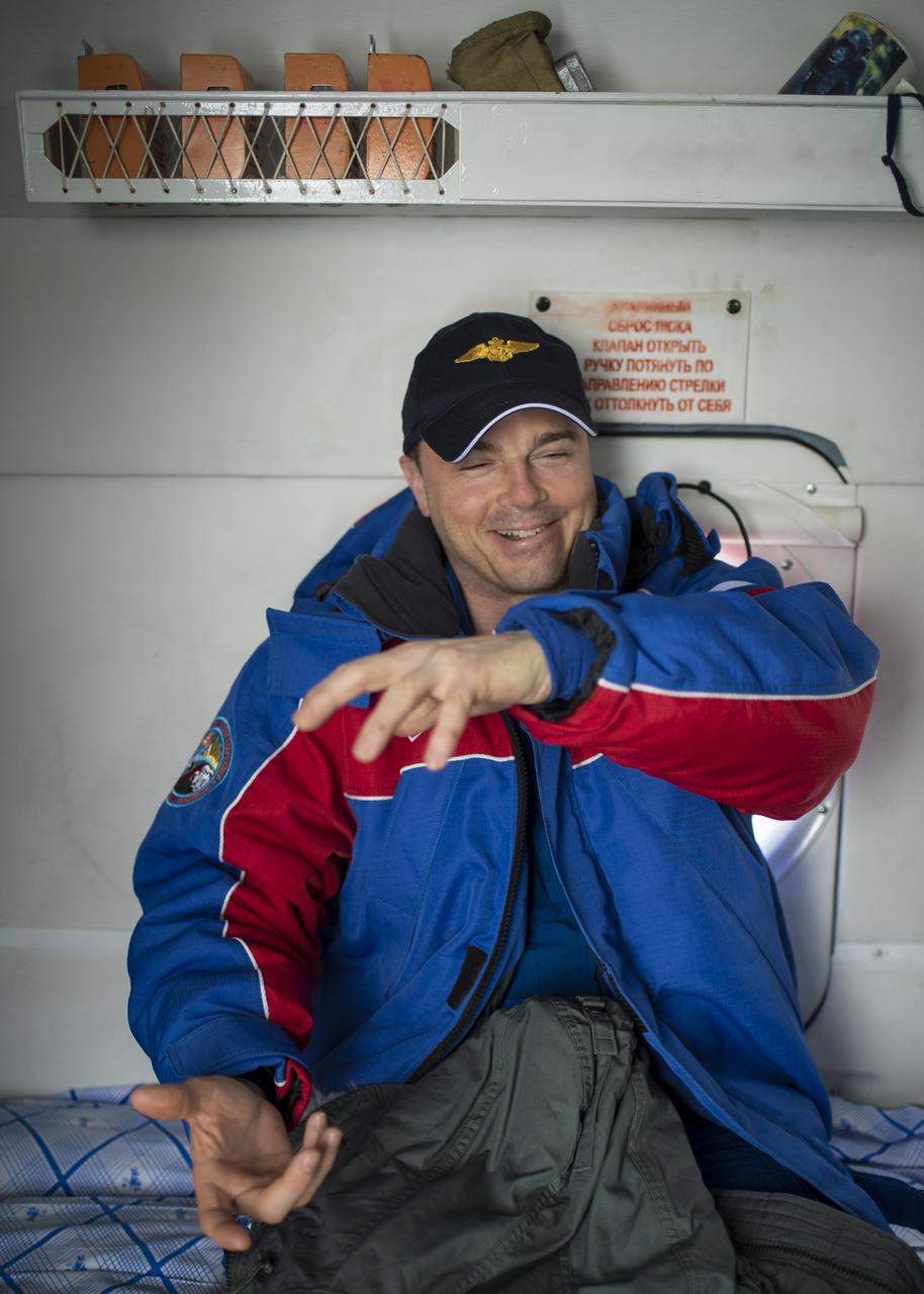 Expedition 41 Flight Engineer Reid Wiseman of NASA sits in a Russian search and rescue helicopter and describes how he felt his Soyuz TMA-13M spacecraft being pulled over by the parachutes after it landed with he and Expedition 41 Commander Max Suraev of the Russian Federal Space Agency (Roscosmos) and Flight Engineer Alexander Gerst of the European Space Agency (ESA) in a remote area near the town of Arkalyk, Kazakhstan on Monday, Nov. 10, 2014. Suraev, Wiseman and Gerst returned to Earth after more than five months onboard the International Space Station where they served as members of the Expedition 40 and 41 crews. Photo Credit: (NASA/Bill Ingalls)