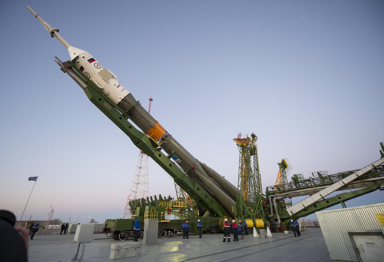 The Soyuz TMA-15M spacecraft is raised into position on the launch pad Friday, Nov. 21, 2014 at the Baikonur Cosmodrome in Kazakhstan. Launch of the Soyuz rocket is scheduled for Nov. 24 and will carry Expedition 42 Soyuz Commander Anton Shkaplerov of the Russian Federal Space Agency (Roscosmos), Flight Engineer Terry Virts of NASA , and Flight Engineer Samantha Cristoforetti of the European Space Agency into orbit to begin their five and a half month mission on the International Space Station. Photo Credit: (NASA/Aubrey Gemignani)