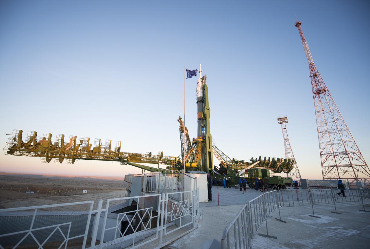 The Soyuz TMA-15M spacecraft is seen after being raised into a vertical position on the launch pad on Friday, Nov. 21, 2014 at the Baikonur Cosmodrome in Kazakhstan.  Launch of the Soyuz rocket is scheduled for Nov. 24 and will carry Expedition 42 Soyuz Commander Anton Shkaplerov of the Russian Federal Space Agency (Roscosmos), Flight Engineer Terry Virts of NASA , and Flight Engineer Samantha Cristoforetti of the European Space Agency into orbit to begin their five and a half month mission on the International Space Station. Photo Credit: (NASA/Aubrey Gemignani)