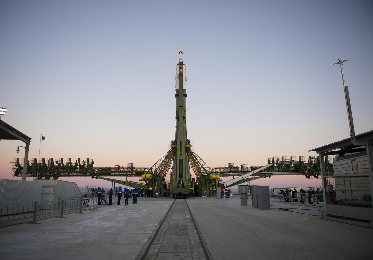 The Soyuz TMA-15M spacecraft is seen after being raised into a vertical position on the launch pad on Friday, Nov. 21, 2014 at the Baikonur Cosmodrome in Kazakhstan.  Launch of the Soyuz rocket is scheduled for Nov. 24 and will carry Expedition 42 Soyuz Commander Anton Shkaplerov of the Russian Federal Space Agency (Roscosmos), Flight Engineer Terry Virts of NASA , and Flight Engineer Samantha Cristoforetti of the European Space Agency into orbit to begin their five and a half month mission on the International Space Station. Photo Credit: (NASA/Aubrey Gemignani)
