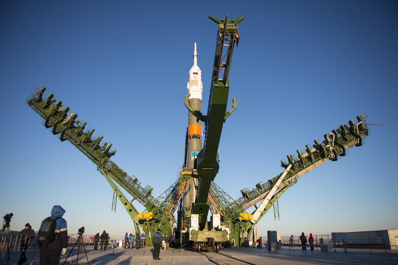 The gantry arms close around the Soyuz TMA-15M spacecraft to secure the rocket at the launch pad on Friday, Nov. 21, 2014 at the Baikonur Cosmodrome in Kazakhstan. Launch of the Soyuz rocket is scheduled for Nov. 24 and will carry Expedition 42 Soyuz Commander Anton Shkaplerov of the Russian Federal Space Agency (Roscosmos), Flight Engineer Terry Virts of NASA , and Flight Engineer Samantha Cristoforetti of the European Space Agency into orbit to begin their five and a half month mission on the International Space Station. Photo Credit: (NASA/Aubrey Gemignani)