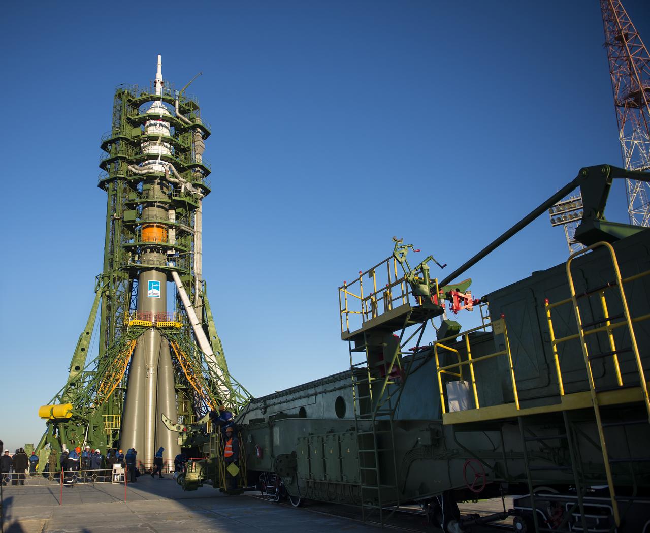 The Soyuz TMA-15M spacecraft is seen after the gantry arms closed  to secure the rocket on the launch pad on Friday, Nov. 21, 2014 at the Baikonur Cosmodrome in Kazakhstan.  Launch of the Soyuz rocket is scheduled for Nov. 24 and will carry Expedition 42 Soyuz Commander Anton Shkaplerov of the Russian Federal Space Agency (Roscosmos), Flight Engineer Terry Virts of NASA , and Flight Engineer Samantha Cristoforetti of the European Space Agency into orbit to begin their five and a half month mission on the International Space Station. Photo Credit: (NASA/Aubrey Gemignani)