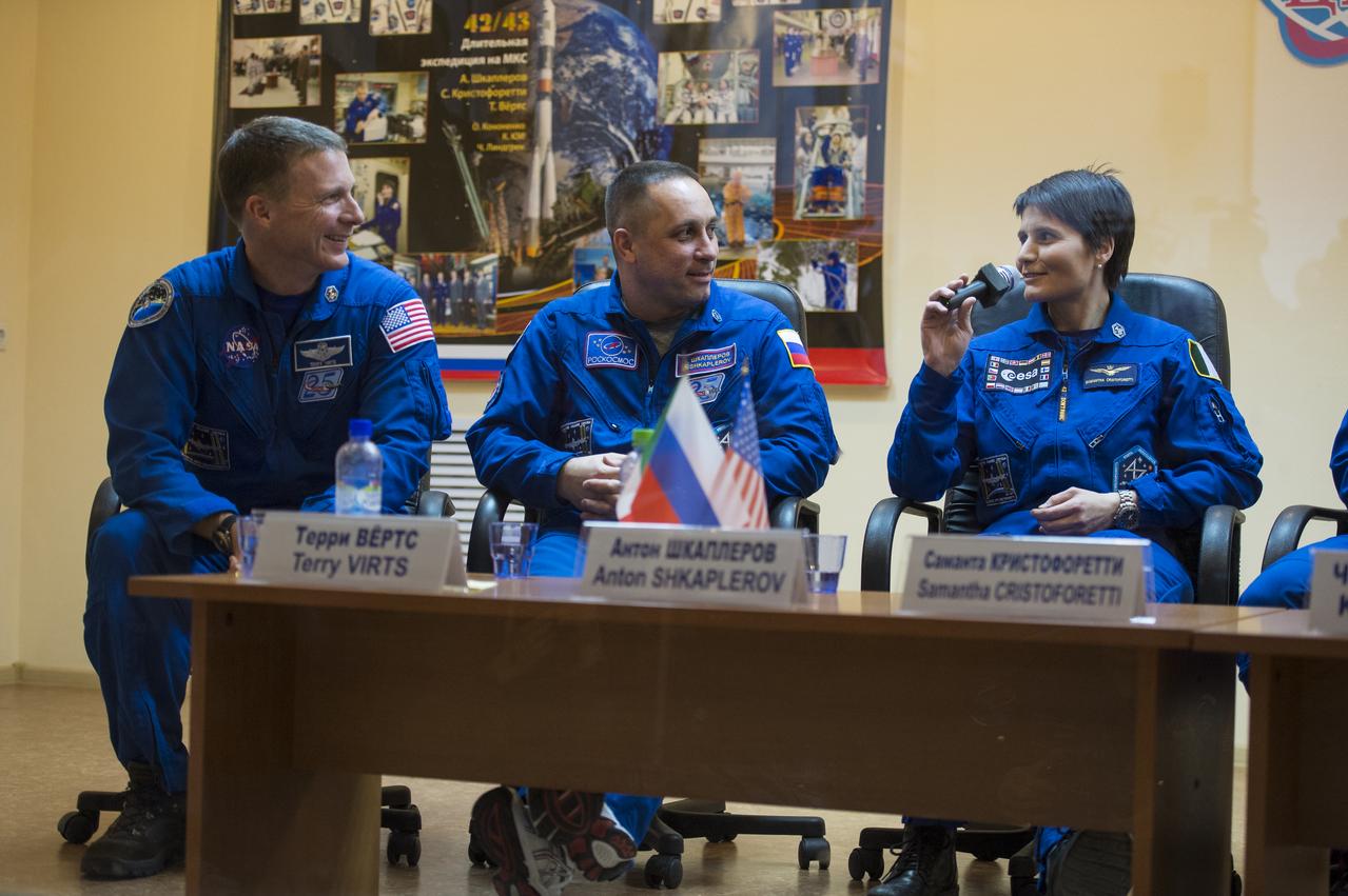 Expedition 42 prime crew members, Flight Engineer Terry Virts of NASA (left), Soyuz Commander Anton Shkaplerov of the Russian Federal Space Agency (Roscosmos) (center), and Flight Engineer Samantha Cristoforetti (right) of the European Space Agency are seen during a press conference held at the Cosmonaut Hotel in Baikonur, Kazakhstan on Saturday, Nov. 22, 2014. The mission is set to launch Nov. 24 from the Baikonur Cosmodrome. Photo Credit: (NASA/Aubrey Gemignani)