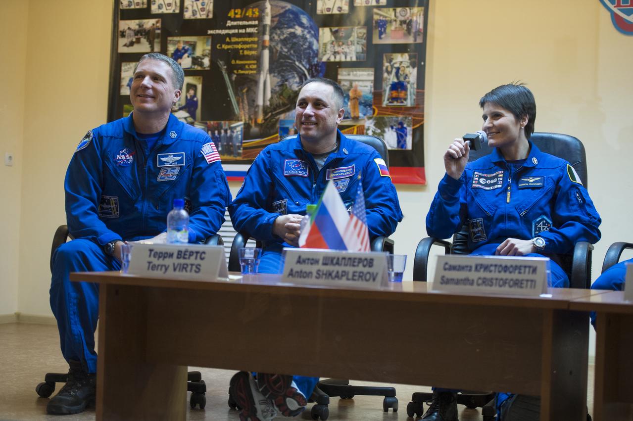 Expedition 42 prime crew members, Flight Engineer Terry Virts of NASA (left), Soyuz Commander Anton Shkaplerov of the Russian Federal Space Agency (Roscosmos) (center), and Flight Engineer Samantha Cristoforetti (right) of the European Space Agency are seen during a press conference held at the Cosmonaut Hotel in Baikonur, Kazakhstan on Saturday, Nov. 22, 2014. The mission is set to launch Nov. 24 from the Baikonur Cosmodrome. Photo Credit: (NASA/Aubrey Gemignani)