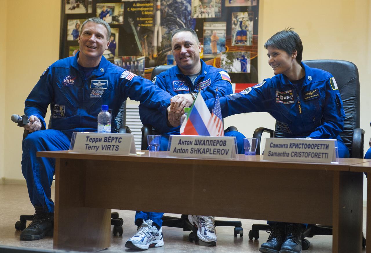 Expedition 42 Flight Engineer Terry Virts of NASA (left), Soyuz Commander Anton Shkaplerov of the Russian Federal Space Agency (Roscosmos) (center), and Flight Engineer Samantha Cristoforetti of the European Space Agency (right), pose for a photo at the conclusion of the press conference, Saturday, Nov. 22, 2014, at the Cosmonaut Hotel in Baikonur, Kazakhstan. The mission to the International Space Station is set to launch Nov. 24 from the Baikonur Cosmodrome. Photo Credit: (NASA/Aubrey Gemignani)