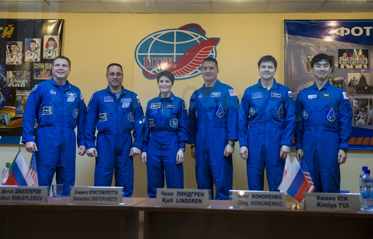 Expedition 42 prime crew members, Flight Engineer Terry Virts of NASA (far left), Soyuz Commander Anton Shkaplerov of the Russian Federal Space Agency (Roscosmos) (second left), and Flight Engineer Samantha Cristoforetti of the European Space Agency (center) pose for a photo with Expedition 42 back up crew members, Flight Engineer Kjell Lindgren of NASA (third right), Soyuz Commander Oleg Kononenko of the Russian Federal Space Agency (Roscosmos) (second right), and Flight Engineeer Kimiya Yui of the Japan Aerospace Exploration Agency (JAXA) (far right) at the conclusion of the press conference held at the Cosmonaut Hotel in Baikonur, Kazakhstan on Saturday, Nov. 22, 2014. The mission is set to launch Nov. 24 from the Baikonur Cosmodrome. Photo Credit: (NASA/Aubrey Gemignani)