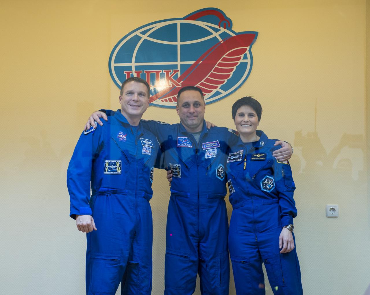 Expedition 42 Flight Engineer Terry Virts of NASA (left), Soyuz Commander Anton Shkaplerov of the Russian Federal Space Agency (Roscosmos) (center), and Flight Engineer Samantha Cristoforetti of the European Space Agency (right), pose for a photo at the conclusion of the press conference, Saturday, Nov. 22, 2014, at the Cosmonaut Hotel in Baikonur, Kazakhstan. The mission to the International Space Station is set to launch Nov. 24 from the Baikonur Cosmodrome. Photo Credit: (NASA/Aubrey Gemignani)