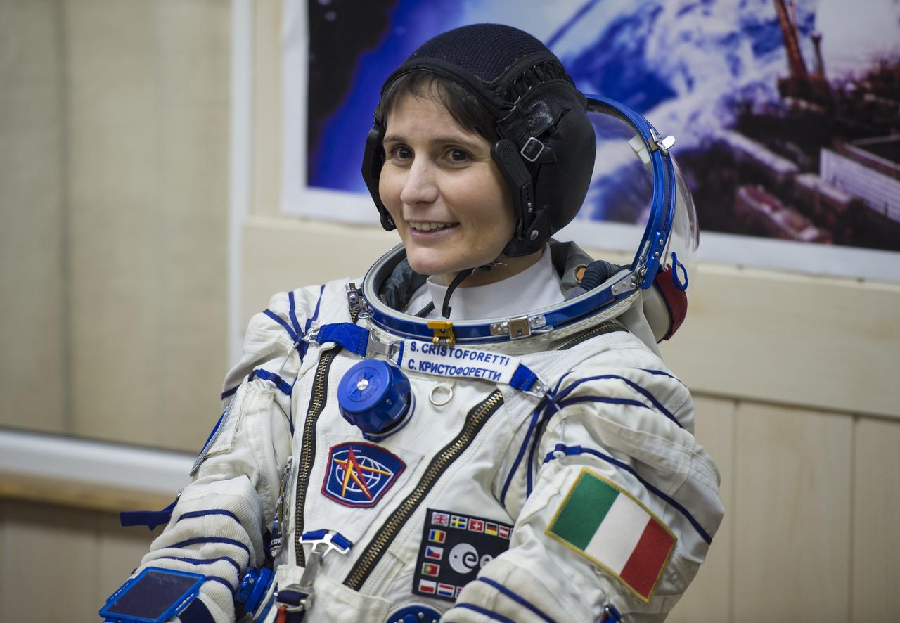 Expedition 42 Flight Engineer Samantha Cristoforetti of the European Space Agency (ESA) waits for a pressure check of her Sokol suit in Building 254 following her suit up for launch, Sunday, Nov. 23, 2014, at the Baikonur Cosmodrome in Kazakhstan. Launch of the Soyuz rocket is scheduled for the early hours of Nov. 24 and will carry Cristoforetti and fellow crewmates, Flight Engineer Terry Virts of NASA and Soyuz Commander Anton Shkaplerov of the Russian Federal Space Agency (Roscosmos) into orbit to begin their five and a half month mission on the International Space Station. Photo Credit: (NASA/Aubrey Gemignani)