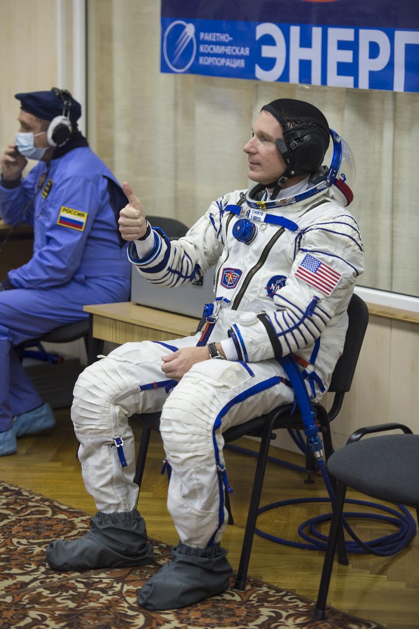 Expedition 42 Flight Engineer Terry Virts of NASA gives a thumbs up while waiting for a pressure check of his Sokol suit in Building 254 following his suit up for launch, Sunday, Nov. 23, 2014, at the Baikonur Cosmodrome in Kazakhstan. Launch of the Soyuz rocket is scheduled for the early hours of Nov. 24 and will carry Virts and fellow crewmates, Flight Engineer Samantha Cristoforetti of the European Space Agency (ESA) and Soyuz Commander Anton Shkaplerov of the Russian Federal Space Agency (Roscosmos) into orbit to begin their five and a half month mission on the International Space Station. Photo Credit: (NASA/Aubrey Gemignani)