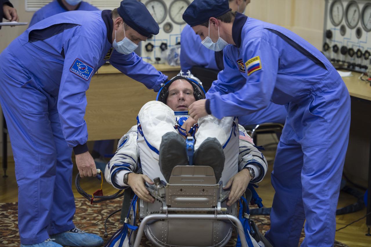 Expedition 42 Flight Engineer Terry Virts has his Russian Sokol suit pressure checked in preparation for his launch aboard the Soyuz TMA-15M spacecraft on Sunday, Nov. 23, 2014, at the Baikonur Cosmodrome in Baikonur, Kazakhstan. Launch of the Soyuz rocket is scheduled for the early hours of Nov. 24 and will carry Virts and fellow crewmates, Flight Engineer Samantha Cristoforetti of the European Space Agency (ESA) and Soyuz Commander Anton Shkaplerov of the Russian Federal Space Agency (Roscosmos) into orbit to begin their five and a half month mission on the International Space Station. Photo Credit: (NASA/Aubrey Gemignani)