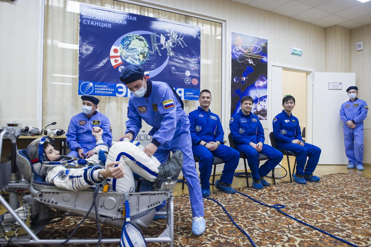 Expedition 42 Flight Engineer Samantha Cristoforetti of the European Space Agency (ESA) has her Russian Sokol suit pressure checked in preparation for her launch aboard the Soyuz TMA-15M spacecraft on Sunday, Nov. 23, 2014, at the Baikonur Cosmodrome in Baikonur, Kazakhstan. Launch of the Soyuz rocket is scheduled for the early hours of Nov. 24 and will carry Cristoforetti and fellow crewmates, Soyuz Commander Anton Shkaplerov of the Russian Federal Space Agency (Roscosmos), and Flight Engineer Terry Virts of NASA, into orbit to begin their five and a half month mission on the International Space Station. Photo Credit: (NASA/GCTC/Andrey Shelepin)