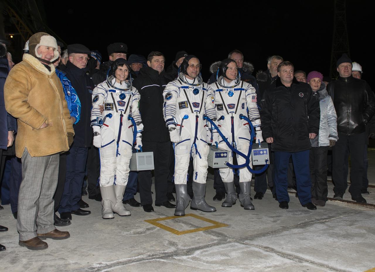 Expedition 42 Flight Engineer Samantha Cristoforetti, of the European Space Agency (ESA), left, Soyuz Commander Anton Shkaplerov of the Russian Federal Space Agency (Roscosmos), center, and Flight Engineer Terry Virts of NASA, right, pose for a photo with senior officials of Roscosmos, NASA, and ESA prior to boarding the Soyuz TMA-15M spacecraft for launch, Monday, Nov. 24, 2014 at the Baikonur Cosmodrome in Kazakhstan. Cristoforetti, Virts, and Shkaplerov will spend the next five and a half months aboard the International Space Station. Photo Credit: (NASA/Aubrey Gemignani)