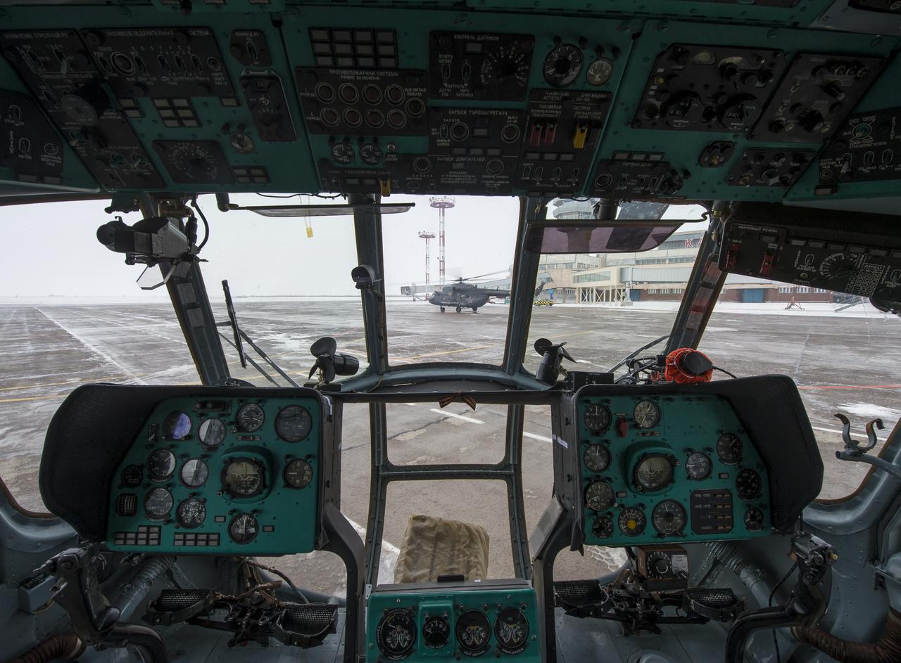 A Russian MI-8 Helicopter is seen through the cockpit of another helicopter a day before the Soyuz TMA-14M spacecraft landing with Expedition 42 commander Barry Wilmore of NASA, Alexander Samokutyaev of the Russian Federal Space Agency (Roscosmos) and Elena Serova of Roscosmos Wednesday, March 11, 2015 in Karaganda, Kazakhstan. NASA Astronaut Wilmore, Russian Cosmonauts Samokutyaev and Serova are returning after almost six months onboard the International Space Station where they served as members of the Expedition 41 and 42 crews. Photo Credit: (NASA/Bill Ingalls)