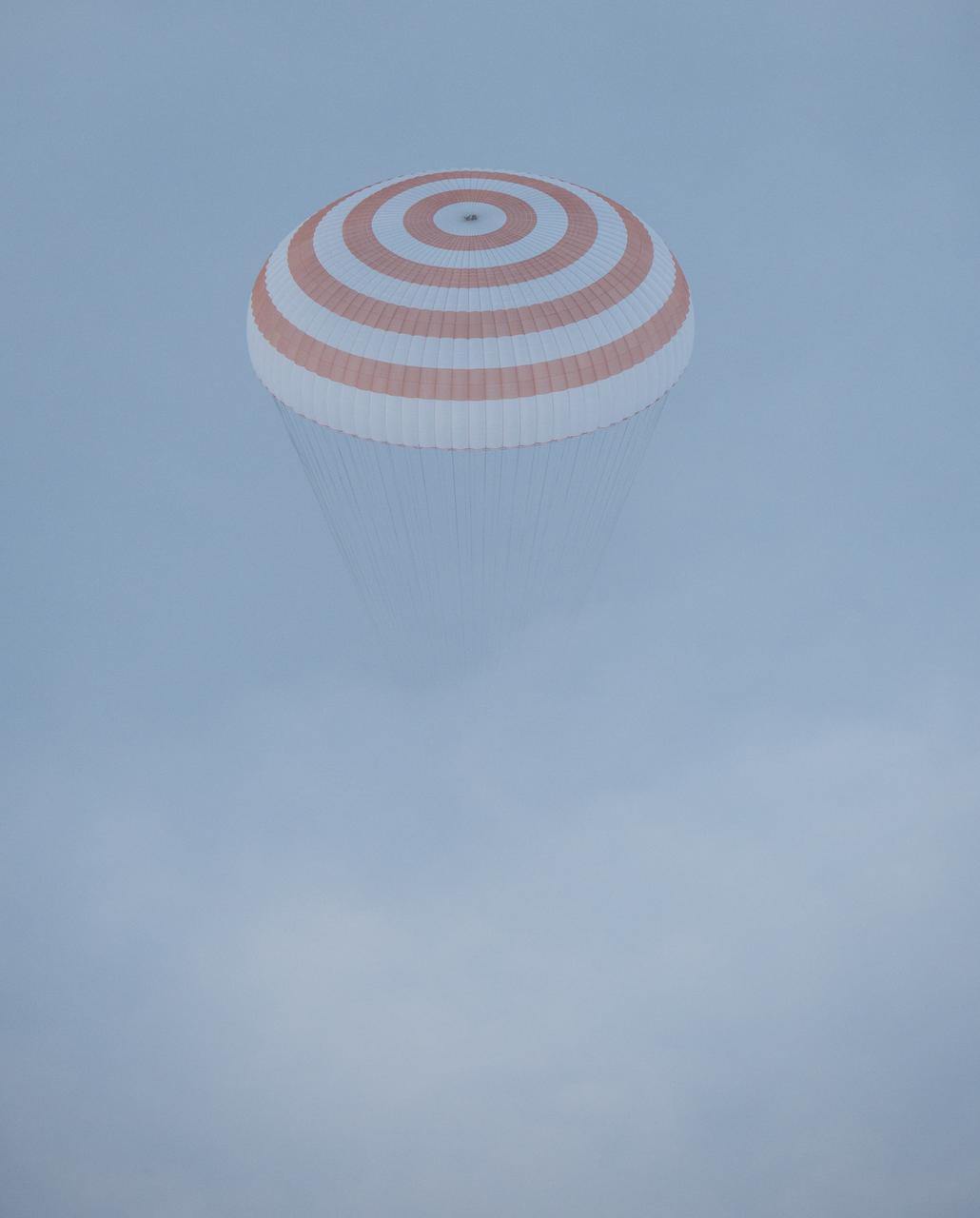 The Soyuz TMA-14M spacecraft is seen as it descends through the fog before landing with Expedition 42 commander Barry Wilmore of NASA, Alexander Samokutyaev of the Russian Federal Space Agency (Roscosmos) and Elena Serova of Roscosmos near the town of Zhezkazgan, Kazakhstan on Thursday, March 12, 2015. NASA Astronaut Wilmore, Russian Cosmonauts Samokutyaev and Serova are returning after almost six months onboard the International Space Station where they served as members of the Expedition 41 and 42 crews. Photo Credit: (NASA/Bill Ingalls)