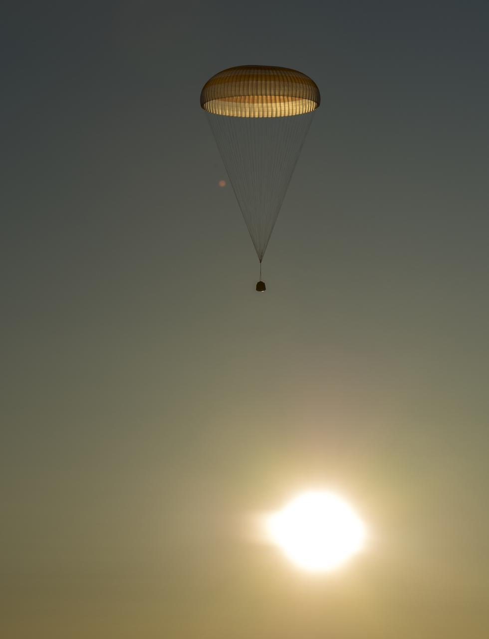 The Soyuz TMA-14M spacecraft is seen as it lands with Expedition 42 commander Barry Wilmore of NASA, Alexander Samokutyaev of the Russian Federal Space Agency (Roscosmos) and Elena Serova of Roscosmos near the town of Zhezkazgan, Kazakhstan on Thursday, March 12, 2015. NASA Astronaut Wilmore, Russian Cosmonauts Samokutyaev and Serova are returning after almost six months onboard the International Space Station where they served as members of the Expedition 41 and 42 crews. Photo Credit: (NASA/Bill Ingalls)