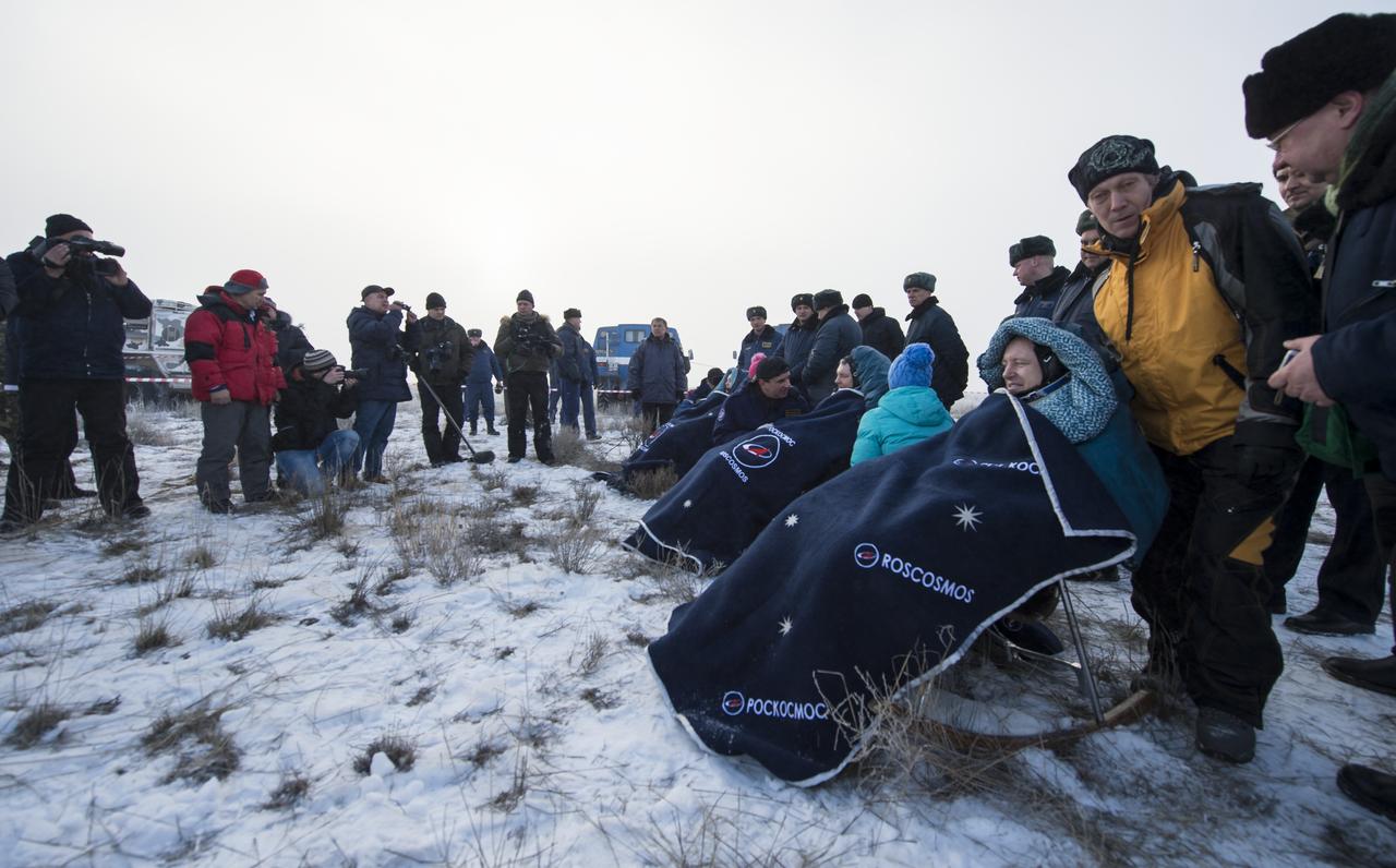 Expedition 42 Cosmonaut Elena Serova of the Russian Federal Space Agency (Roscosmos, seated left, Alexander Samokutyaev of Roscosmos, center, and NASA Astronaut Barry Wilmore of NASA sit in chairs outside the Soyuz TMA-14M spacecraft just minutes after they landed in a remote area near the town of Zhezkazgan, Kazakhstan on Thursday, March 12, 2015. NASA Astronaut Wilmore, Russian Cosmonauts Samokutyaev and Serova are returning after almost six months onboard the International Space Station where they served as members of the Expedition 41 and 42 crews. Photo Credit: (NASA/Bill Ingalls)