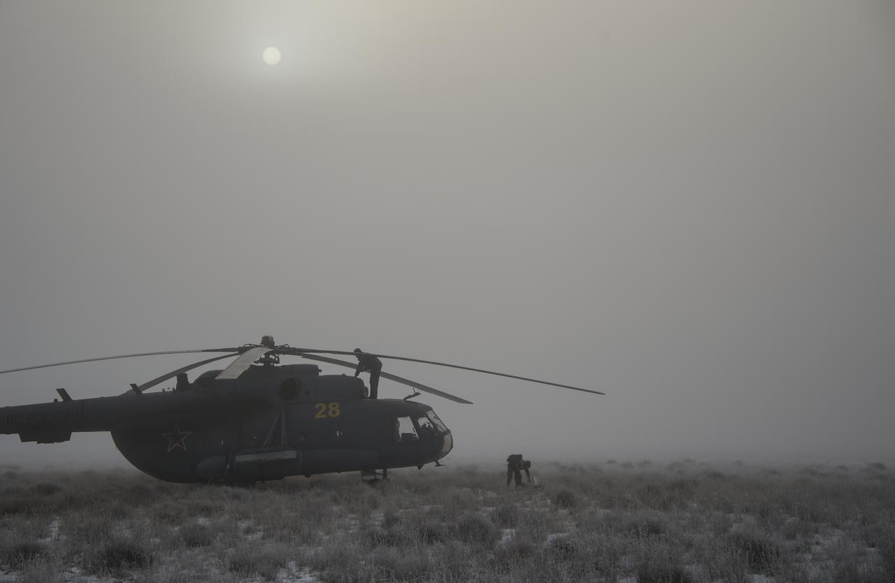 Russian MI-8 helicopter personnel work on their helicopters at the Soyuz TMA-14M spacecraft landing site shortly after the capsule landed with Expedition 42 commander Barry Wilmore of NASA, Alexander Samokutyaev of the Russian Federal Space Agency (Roscosmos) and Elena Serova of Roscosmos near the town of Zhezkazgan, Kazakhstan on Thursday, March 12, 2015. NASA Astronaut Wilmore, Russian Cosmonauts Samokutyaev and Serova are returning after almost six months onboard the International Space Station where they served as members of the Expedition 41 and 42 crews. Photo Credit: (NASA/Bill Ingalls)