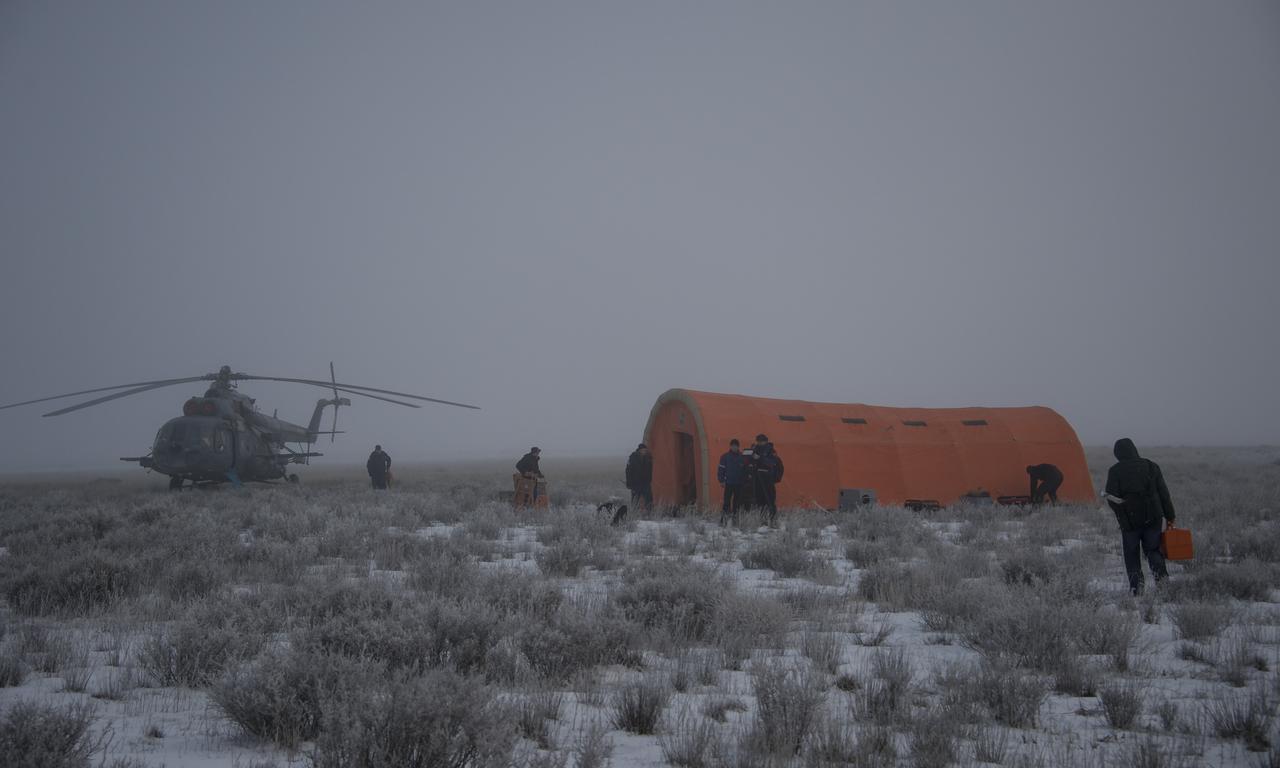 Russian ground support personnel assemble a portable medical tent at the Soyuz TMA-14M spacecraft landing site shortly after the capsule landed with Expedition 42 commander Barry Wilmore of NASA, Alexander Samokutyaev of the Russian Federal Space Agency (Roscosmos) and Elena Serova of Roscosmos near the town of Zhezkazgan, Kazakhstan on Thursday, March 12, 2015. NASA Astronaut Wilmore, Russian Cosmonauts Samokutyaev and Serova are returning after almost six months onboard the International Space Station where they served as members of the Expedition 41 and 42 crews. Photo Credit: (NASA/Bill Ingalls)