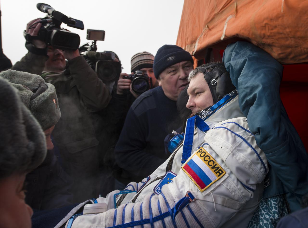 Expedition 42 Cosmonaut Alexander Samokutyaev of the Russian Federal Space Agency (Roscosmos) is carried in a chair from an all terrain vehicle (ATV) to a medical tent just minutes after he and NASA Astronaut Barry Wilmore of NASA, and Elena Serova of Roscosmos landed in their Soyuz TMA-14M spacecraft in a remote area near the town of Zhezkazgan, Kazakhstan on Thursday, March 12, 2015. NASA Astronaut Wilmore, Russian Cosmonauts Samokutyaev and Serova are returning after almost six months onboard the International Space Station where they served as members of the Expedition 41 and 42 crews. Photo Credit: (NASA/Bill Ingalls)