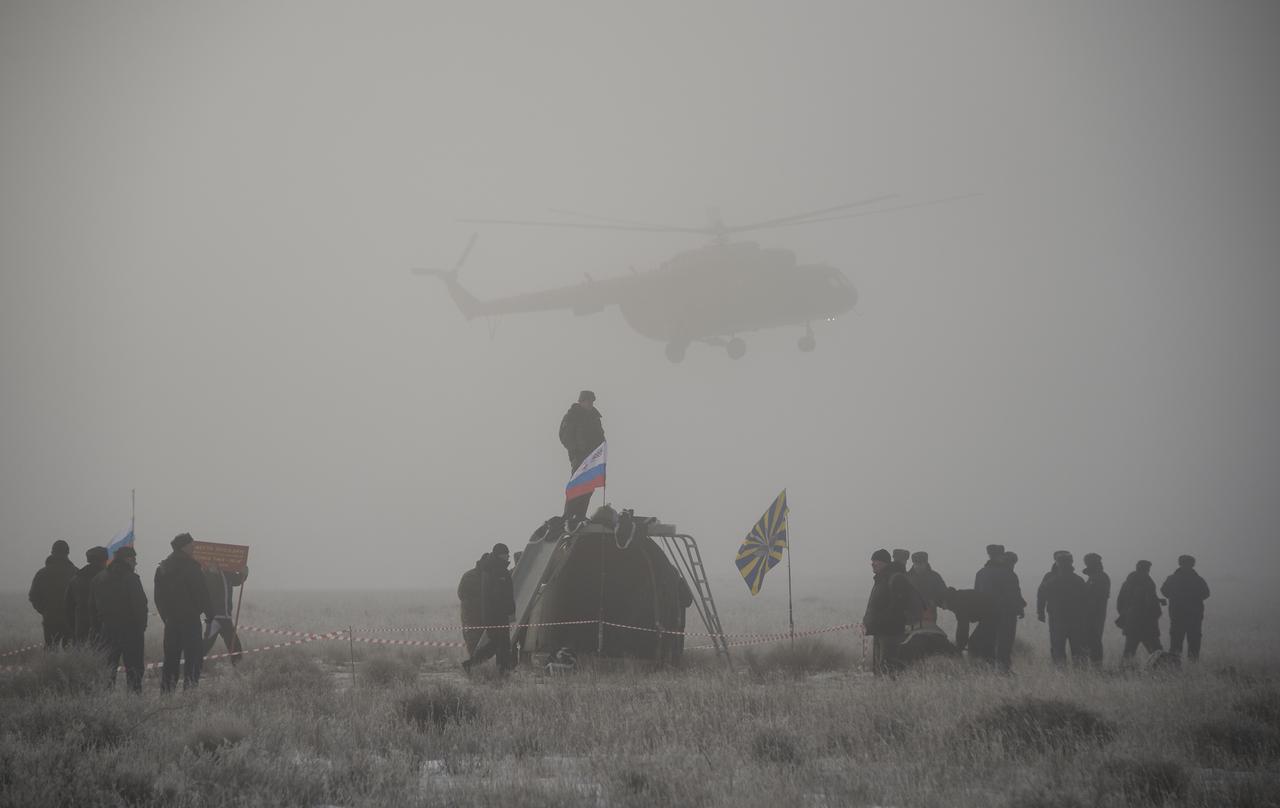 Russian support personnel work around the Soyuz TMA-14M spacecraft after it landed with Expedition 42 commander Barry Wilmore of NASA, Alexander Samokutyaev of the Russian Federal Space Agency (Roscosmos) and Elena Serova of Roscosmos near the town of Zhezkazgan, Kazakhstan on Thursday, March 12, 2015. NASA Astronaut Wilmore, Russian Cosmonauts Samokutyaev and Serova are returning after almost six months onboard the International Space Station where they served as members of the Expedition 41 and 42 crews. Photo Credit: (NASA/Bill Ingalls)