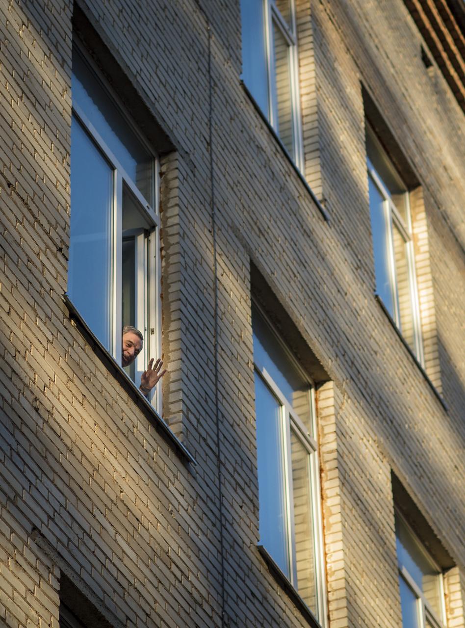 Expedition 43 Cosmonaut Mikhail Kornienko of the Russian Federal Space Agency (Roscosmos), waves out a window to fellow crew mates, NASA Astronaut Scott Kelly, and, Russian Cosmonaut Gennady Padalka of Roscosmos, as they prepare to depart the Gagarin Cosmonaut Training Center (GCTC) in Star City, Russia for Baikonur, Kazakhstan, Saturday, March 14, 2015, Star City, Russia. The trio is preparing for launch to the International Space Station in their Soyuz TMA-16M spacecraft from the Baikonur Cosmodrome in Kazakhstan March 28, Kazakh time. As the one-year crew, Kelly and Kornienko will return to Earth on Soyuz TMA-18M in March 2016. Photo Credit: (NASA/Bill Ingalls)