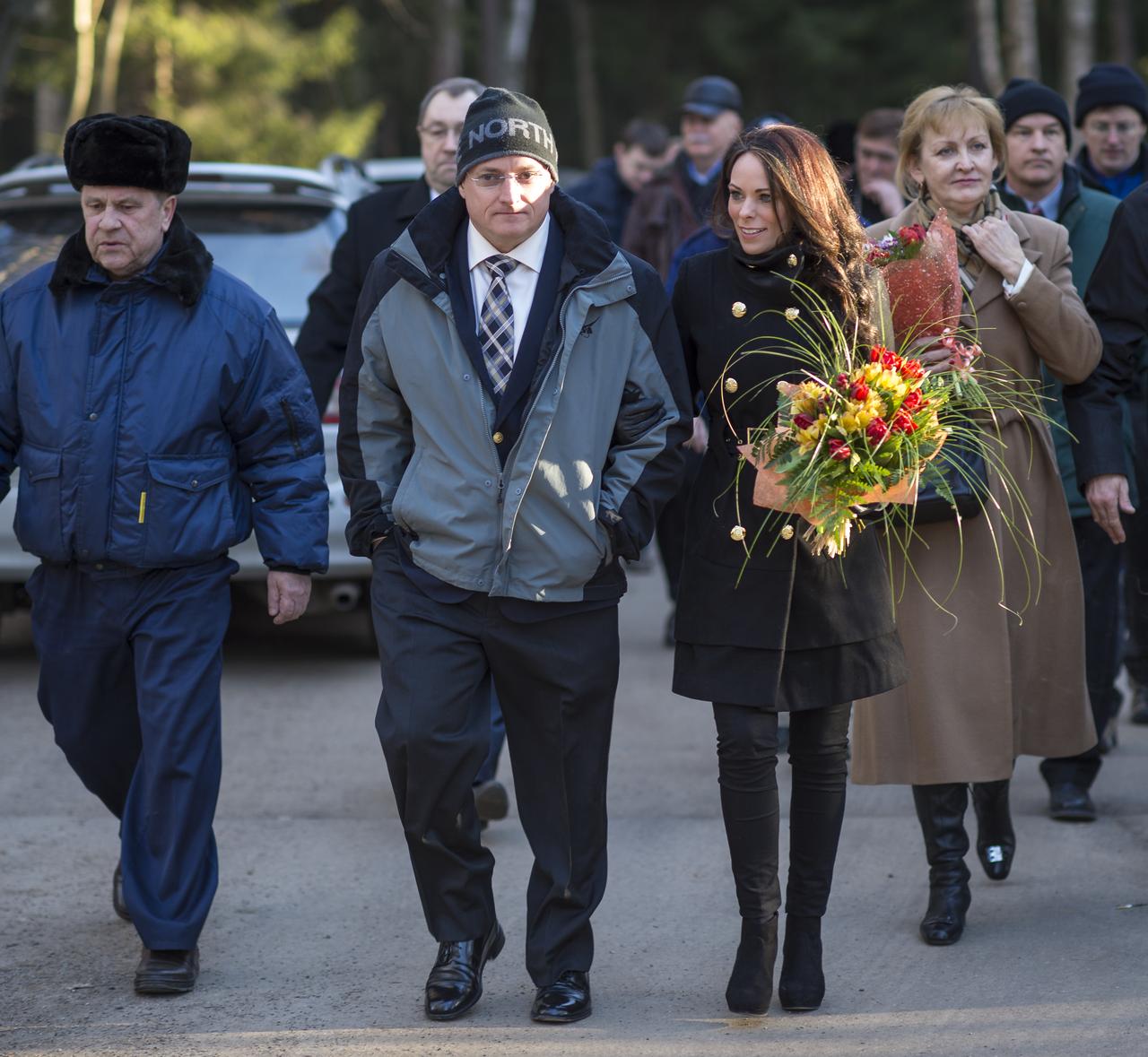 Expedition 43 NASA Astronaut Scott Kelly, and girlfriend, Amiko Kauderer, walk with fellow Expedition 43 crew members, family, friends as the crew departs the Gagarin Cosmonaut Training Center (GCTC) in Star City, Russia, for Baikonur, Kazakhstan, Saturday, March 14, 2015. Kelly and fellow Expedition 43 crew members, Russian Cosmonauts Mikhail Kornienko and Gennady Padalka of the Russian Federal Space Agency (Roscosmos) are preparing for launch to the International Space Station in their Soyuz TMA-16M spacecraft from the Baikonur Cosmodrome in Kazakhstan March 28, Kazakh time. As the one-year crew, Kelly and Kornienko will return to Earth on Soyuz TMA-18M in March 2016. Photo Credit: (NASA/Bill Ingalls)