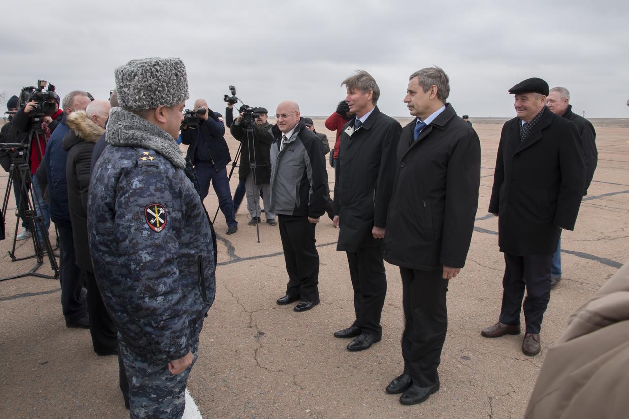 Expedition 43 NASA Astronaut Scott Kelly, left, Russian Cosmonauts Gennady Padalka, center, and Mikhail Kornienko of the Russian Federal Space Agency (Roscosmos) are welcomed by officials after arriving in Baikonur, Kazakhstan, Saturday, March 14, 2015. The trio are preparing for launch to the International Space Station in their Soyuz TMA-16M spacecraft from the Baikonur Cosmodrome in Kazakhstan March 28, Kazakh time. As the one-year crew, Kelly and Kornienko will return to Earth on Soyuz TMA-18M in March 2016. Photo Credit: (NASA/Victor Zelentsov)