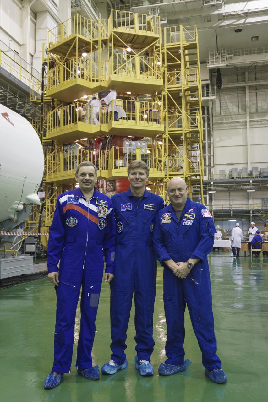 Expedition 43 Russian Cosmonauts Mikhail Kornienko, left, Gennady Padalka of the Russian Federal Space Agency (Roscosmos), and, NASA Astronaut Scott Kelly take a moment during their Soyuz TMA-16M spacecraft fit check to pose for a photograph, Sunday, March 15, 2015 at the Baikonur Cosmodrome in Kazakhstan.  The trio are preparing for launch to the International Space Station in their Soyuz TMA-16M spacecraft from the Baikonur Cosmodrome in Kazakhstan March 28, Kazakh time. As the one-year crew, Kelly and Kornienko will return to Earth on Soyuz TMA-18M in March 2016. Photo Credit: (NASA/Victor Zelentsov)
