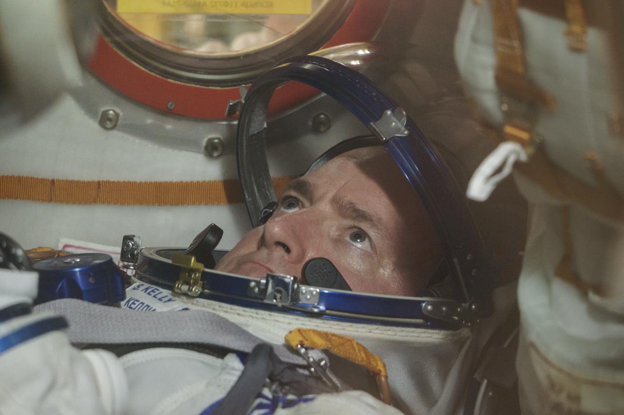 Expedition 43 NASA Astronaut Scott Kelly is seen inside the Soyuz TMA-16M spacecraft during the fit check with Russian Cosmonauts Gennady Padalka and, Mikhail Kornienko of the Russian Federal Space Agency (Roscosmos), Sunday, March 15, 2015 at the Baikonur Cosmodrome in Kazakhstan. The trio are preparing for launch to the International Space Station in their Soyuz TMA-16M spacecraft from the Baikonur Cosmodrome in Kazakhstan March 28, Kazakh time. As the one-year crew, Kelly and Kornienko will return to Earth on Soyuz TMA-18M in March 2016. Photo Credit: (NASA/Victor Zelentsov)