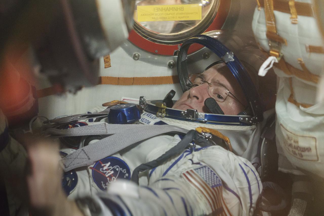 Expedition 43 NASA Astronaut Scott Kelly is seen inside the Soyuz TMA-16M spacecraft during the fit check with Russian Cosmonauts Gennady Padalka and, Mikhail Kornienko of the Russian Federal Space Agency (Roscosmos), Sunday, March 15, 2015 at the Baikonur Cosmodrome in Kazakhstan. The trio are preparing for launch to the International Space Station in their Soyuz TMA-16M spacecraft from the Baikonur Cosmodrome in Kazakhstan March 28, Kazakh time. As the one-year crew, Kelly and Kornienko will return to Earth on Soyuz TMA-18M in March 2016. Photo Credit: (NASA/Victor Zelentsov)