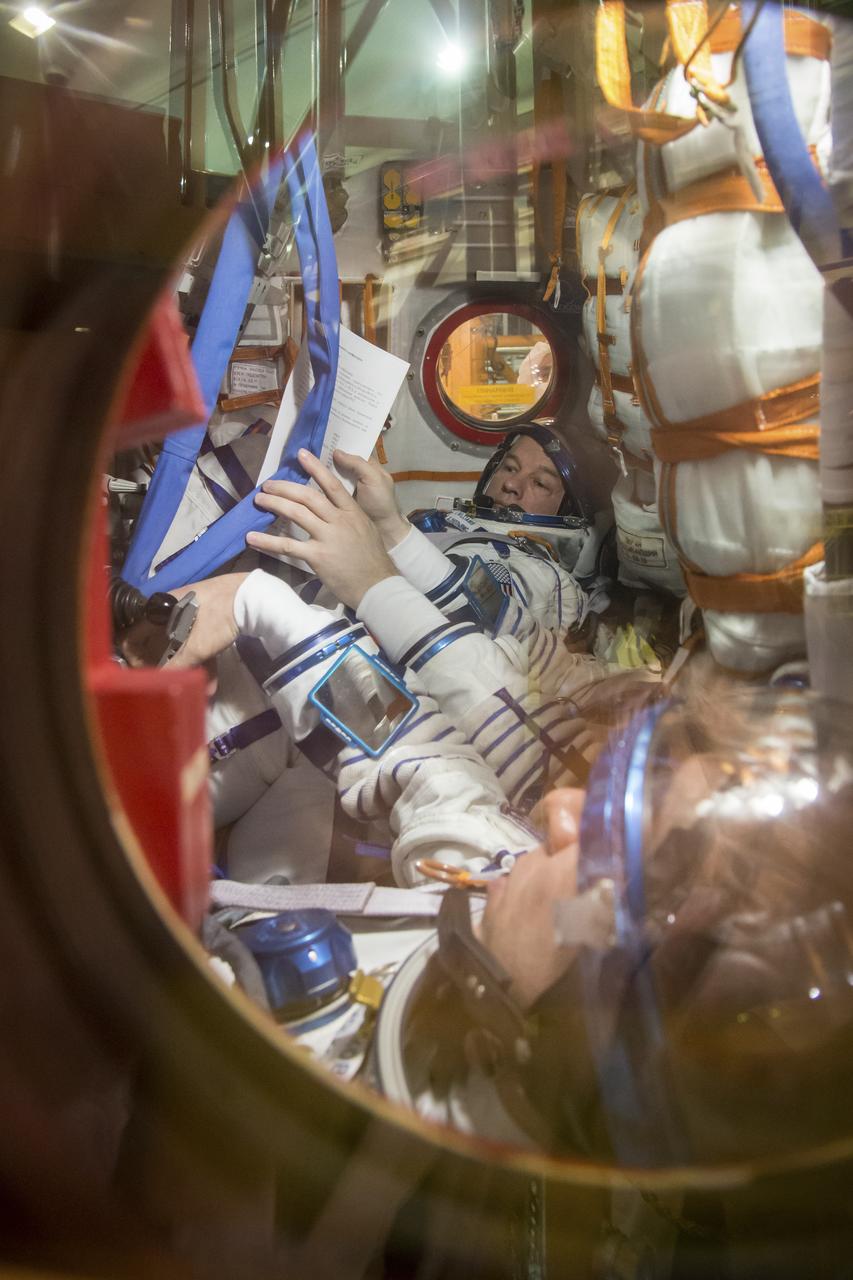 Expedition 43 backup crew member Jeff Williams of NASA is seen inside the Soyuz TMA-16M spacecraft during the fit check with fellow backup crew members Russian Cosmonauts Alexey Ovchinin, and Sergei Volkov of Russia's Federal Space Agency (Roscosmos), Sunday, March 15, 2015 at the Baikonur Cosmodrome in Kazakhstan. The prime crew members Russian Cosmonauts Mikhail Kornienko, Gennady Padalka of the Russian Federal Space Agency (Roscosmos), and NASA Astronaut Scott Kelly are preparing for launch to the International Space Station in their Soyuz TMA-16M spacecraft from the Baikonur Cosmodrome in Kazakhstan March 28, Kazakh time. As the one-year crew, Kelly and Kornienko will return to Earth on Soyuz TMA-18M in March 2016. Photo Credit: (NASA/Victor Zelentsov)