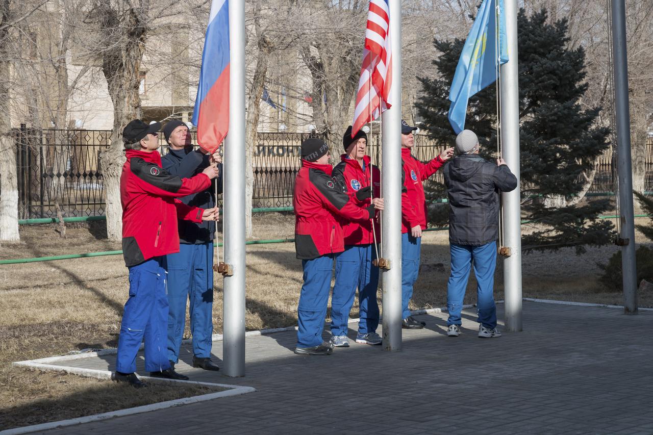 Expedition 43 prime and backup crew members: Russian Cosmonauts Mikhail Kornienko, left, Gennady Padalka, of the Russian Federal Space Agency (Roscosmos), NASA Astronauts Scott Kelly, and Jeff Williams, andRussian Cosmonauts, Alexei Ovchinin, and Sergei Volkov of Roscosmos participate in the traditional flag raising ceremony at the Cosmonaut Hotel, Monday, March 16, 2015 in Baikonur, Kazakhstan. Kelly, Padalka, and Kornienko are preparing for launch to the International Space Station in their Soyuz TMA-16M spacecraft from the Baikonur Cosmodrome in Kazakhstan March 28, Kazakh time. As the one-year crew, Kelly and Kornienko will return to Earth on Soyuz TMA-18M in March 2016. Photo Credit: (NASA/Victor Zelentsov)