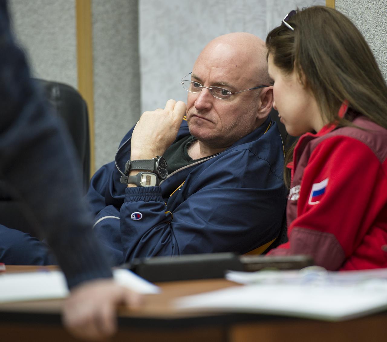 Expedition 43 NASA Astronaut Scott Kelly listens to an interpreter  during an ISS Russian Segment Safety briefing, Thursday, March 19, 2015 at Cosmonaut Hotel in Baikonur, Kazakhstan. Kelly, and Russian Cosmonauts Gennady Padalka, and Mikhail Kornienko of the Russian Federal Space Agency (Roscosmos) are preparing for launch to the International Space Station in their Soyuz TMA-16M spacecraft from the Baikonur Cosmodrome in Kazakhstan March 28, Kazakh time. As the one-year crew, Kelly and Kornienko will return to Earth on Soyuz TMA-18M in March 2016. Photo Credit: (NASA/Bill Ingalls)