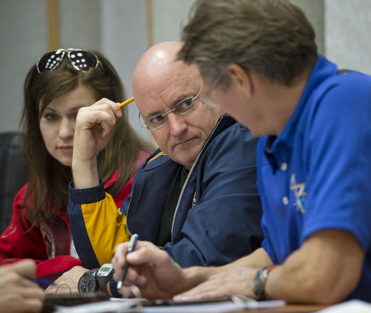 Expedition 43 NASA Astronaut Scott Kelly, left, talks with Russian Cosmonaut Gennady Padalka of the Russian Federal Space Agency (Roscosmos) during an Soyuz TMA-16M Trajectory and Flight Plan briefing, Thursday, March 19, 2015 at Cosmonaut Hotel in Baikonur, Kazakhstan. Kelly, and Russian Cosmonauts Gennady Padalka, and Mikhail Kornienko of Roscosmos are preparing for launch to the International Space Station in their Soyuz TMA-16M spacecraft from the Baikonur Cosmodrome in Kazakhstan March 28, Kazakh time. As the one-year crew, Kelly and Kornienko will return to Earth on Soyuz TMA-18M in March 2016. Photo Credit: (NASA/Bill Ingalls)