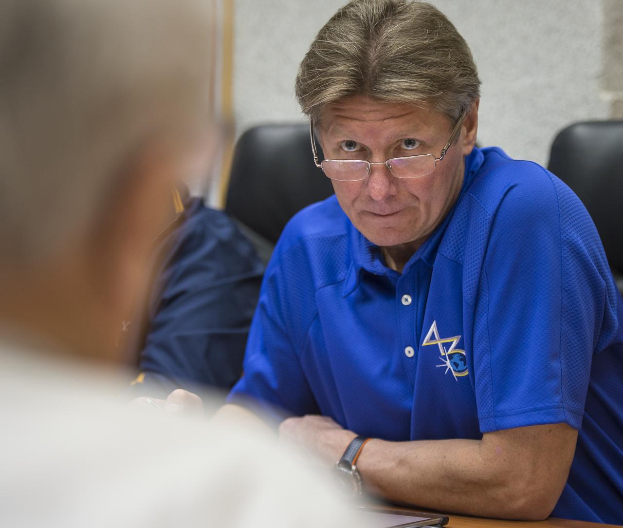 Expedition 43 Russian Cosmonaut Gennady Padalka of the Russian Federal Space Agency (Roscosmos) talks with an instructor during an Soyuz TMA-16M Trajectory and Flight Plan briefing, Thursday, March 19, 2015 at Cosmonaut Hotel in Baikonur, Kazakhstan. Padalka, Russian Cosmonaut Mikhail Kornienko of Roscosmos and NASA Astronaut Scott Kelly are preparing for launch to the International Space Station in their Soyuz TMA-16M spacecraft from the Baikonur Cosmodrome in Kazakhstan March 28, Kazakh time. As the one-year crew, Kelly and Kornienko will return to Earth on Soyuz TMA-18M in March 2016. Photo Credit: (NASA/Bill Ingalls)