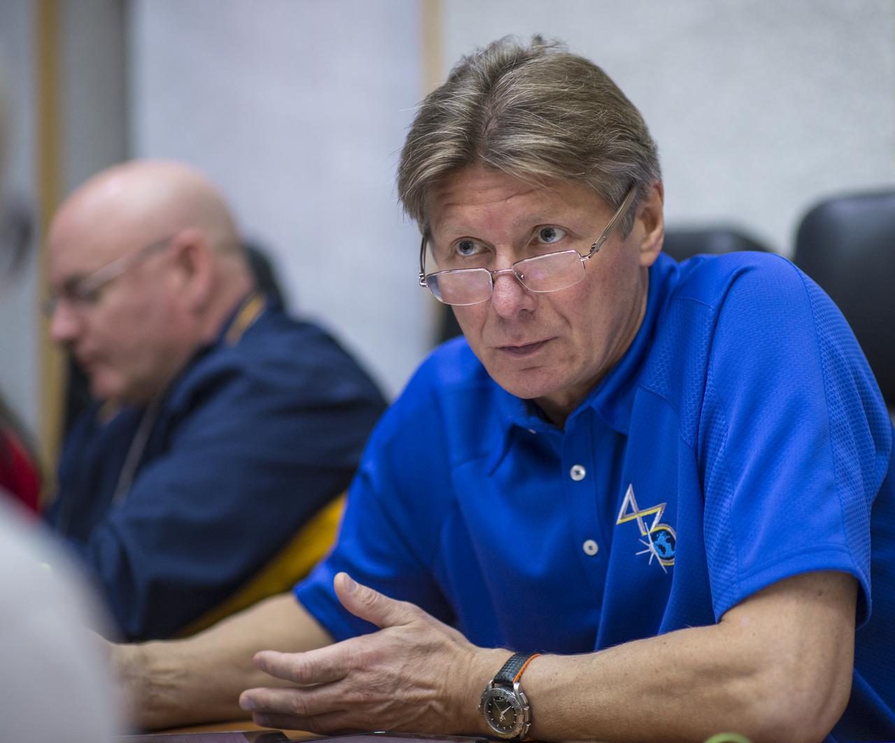 Expedition 43 Russian Cosmonaut Gennady Padalka of the Russian Federal Space Agency (Roscosmos) talks with an instructor during an Soyuz TMA-16M Trajectory and Flight Plan briefing, Thursday, March 19, 2015 at Cosmonaut Hotel in Baikonur, Kazakhstan. Padalka, Russian Cosmonaut Mikhail Kornienko of Roscosmos and NASA Astronaut Scott Kelly are preparing for launch to the International Space Station in their Soyuz TMA-16M spacecraft from the Baikonur Cosmodrome in Kazakhstan March 28, Kazakh time. As the one-year crew, Kelly and Kornienko will return to Earth on Soyuz TMA-18M in March 2016. Photo Credit: (NASA/Bill Ingalls)