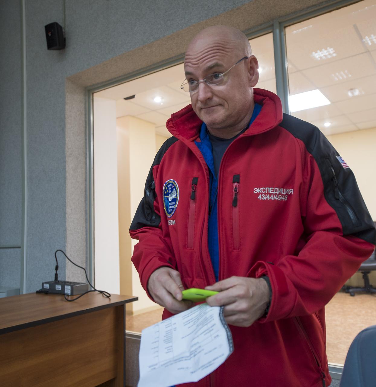 Expedition 43 NASA Astronaut Scott Kelly prepares to depart the Cosmonaut Hotel after having conducted a television interview, Thursday, March 19, 2015 in Baikonur, Kazakhstan. Kelly, and Russian Cosmonauts Gennady Padalka, and Mikhail Kornienko of the Russian Federal Space Agency (Roscosmos) are preparing for launch to the International Space Station in their Soyuz TMA-16M spacecraft from the Baikonur Cosmodrome in Kazakhstan March 28, Kazakh time. As the one-year crew, Kelly and Kornienko will return to Earth on Soyuz TMA-18M in March 2016. Photo Credit: (NASA/Bill Ingalls)