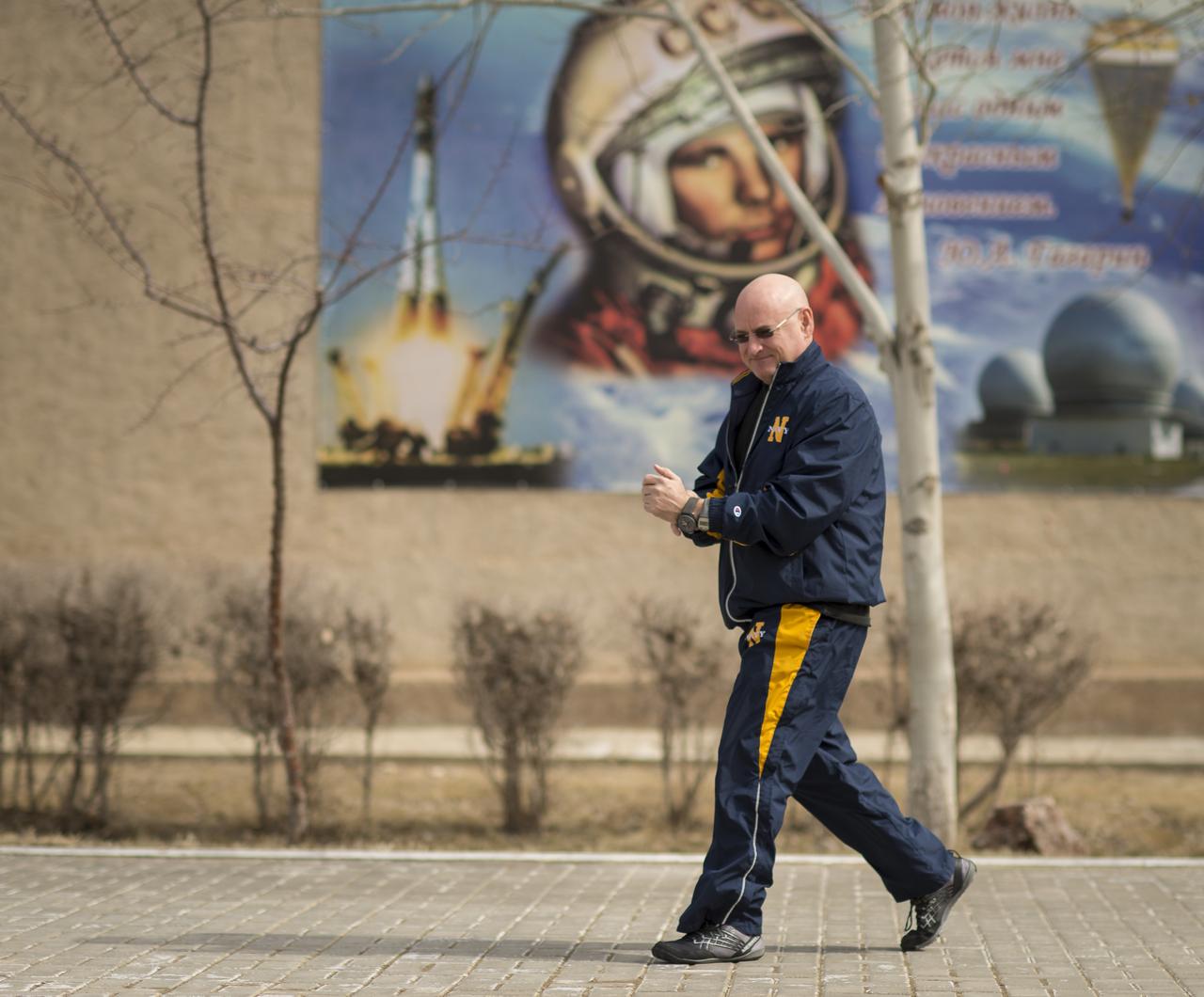 Expedition 43 NASA Astronaut Scott Kelly walks from the Zvjozdnyj Hotel to the Cosmonaut Hotel for additional training, Thursday, March 19, 2015 in Baikonur, Kazakhstan. Kelly, and Russian Cosmonauts Gennady Padalka, and Mikhail Kornienko of the Russian Federal Space Agency (Roscosmos) are preparing for launch to the International Space Station in their Soyuz TMA-16M spacecraft from the Baikonur Cosmodrome in Kazakhstan March 28, Kazakh time. As the one-year crew, Kelly and Kornienko will return to Earth on Soyuz TMA-18M in March 2016. Photo Credit: (NASA/Bill Ingalls)