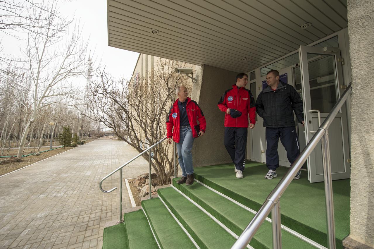 Expedition 43 backup crew members Jeff Williams of NASA, left, Sergei Volkov, center, and Alexey Ovchinin, of the Russian Federal Space Agency (Roscosmos) depart the Cosmonaut Hotel after morning classes, Thursday, March 19, 2015 in Baikonur, Kazakhstan. NASA Astronaut Scott Kelly, and Russian Cosmonauts Gennady Padalka, and Mikhail Kornienko of the Russian Federal Space Agency (Roscosmos) are preparing for launch to the International Space Station in their Soyuz TMA-16M spacecraft from the Baikonur Cosmodrome in Kazakhstan March 28, Kazakh time. As the one-year crew, Kelly and Kornienko will return to Earth on Soyuz TMA-18M in March 2016. Photo Credit: (NASA/Bill Ingalls)