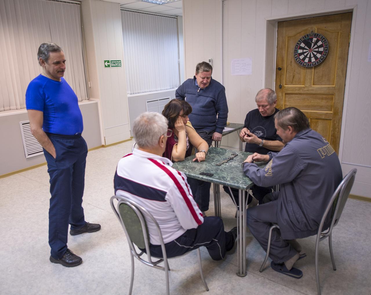 Expedition 43 Russian Cosmonaut Mikhail Kornienko of the Russian Federal Space Agency (Roscosmos), left, relaxes with staff at the Cosmonaut Hotel, Thursday, March 19, 2015 in Baikonur, Kazakhstan. Kornienko, fellow Russian Cosmonaut Gennady Padalka, and NASA Astronaut Scott Kelly are preparing for launch to the International Space Station in their Soyuz TMA-16M spacecraft from the Baikonur Cosmodrome in Kazakhstan March 28, Kazakh time. As the one-year crew, Kelly and Kornienko will return to Earth on Soyuz TMA-18M in March 2016. Photo Credit: (NASA/Bill Ingalls)