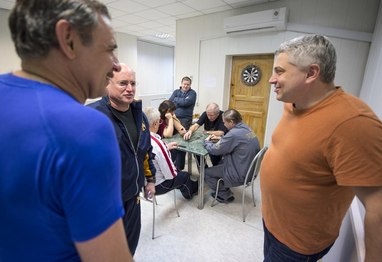Expedition 43 Russian Cosmonaut Mikhail Kornienko of the Russian Federal Space Agency (Roscosmos), left, and NASA Astronaut Scott Kelly talk with staff while relaxing at the Cosmonaut Hotel, Thursday, March 19, 2015 in Baikonur, Kazakhstan. Kelly, Kornienko, and Russian Cosmonaut Gennady Padalka are preparing for launch to the International Space Station in their Soyuz TMA-16M spacecraft from the Baikonur Cosmodrome in Kazakhstan March 28, Kazakh time. As the one-year crew, Kelly and Kornienko will return to Earth on Soyuz TMA-18M in March 2016. Photo Credit: (NASA/Bill Ingalls)