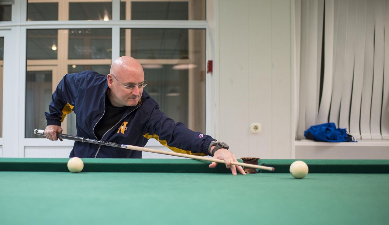 Expedition 43 NASA Astronaut Scott Kelly plays pool with Russian Cosmonaut Mikhail Kornienko of the Russian Federal Space Agency (Roscosmos) at the Cosmonaut Hotel, Thursday, March 19, 2015 in Baikonur, Kazakhstan. Kelly, Kornienko, and Russian Cosmonaut Gennady Padalka are preparing for launch to the International Space Station in their Soyuz TMA-16M spacecraft from the Baikonur Cosmodrome in Kazakhstan March 28, Kazakh time. As the one-year crew, Kelly and Kornienko will return to Earth on Soyuz TMA-18M in March 2016. Photo Credit: (NASA/Bill Ingalls)