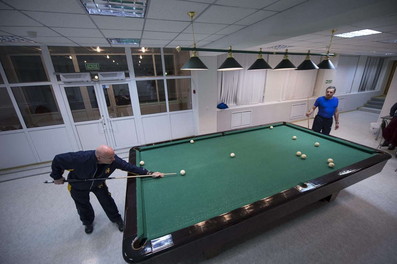 Expedition 43 NASA Astronaut Scott Kelly, left, plays pool with Russian Cosmonaut Mikhail Kornienko of the Russian Federal Space Agency (Roscosmos) at the Cosmonaut Hotel, Thursday, March 19, 2015 in Baikonur, Kazakhstan. Kelly, Kornienko, and Russian Cosmonaut Gennady Padalka are preparing for launch to the International Space Station in their Soyuz TMA-16M spacecraft from the Baikonur Cosmodrome in Kazakhstan March 28, Kazakh time. As the one-year crew, Kelly and Kornienko will return to Earth on Soyuz TMA-18M in March 2016. Photo Credit: (NASA/Bill Ingalls)