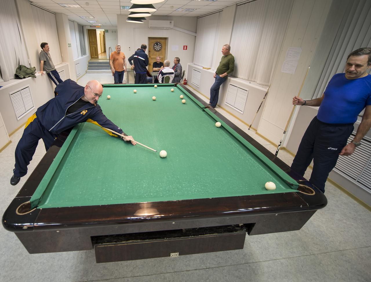 Expedition 43 NASA Astronaut Scott Kelly, left, plays pool with Russian Cosmonaut Mikhail Kornienko of the Russian Federal Space Agency (Roscosmos) at the Cosmonaut Hotel, Thursday, March 19, 2015 in Baikonur, Kazakhstan. Kelly, Kornienko, and Russian Cosmonaut Gennady Padalka are preparing for launch to the International Space Station in their Soyuz TMA-16M spacecraft from the Baikonur Cosmodrome in Kazakhstan March 28, Kazakh time. As the one-year crew, Kelly and Kornienko will return to Earth on Soyuz TMA-18M in March 2016. Photo Credit: (NASA/Bill Ingalls)