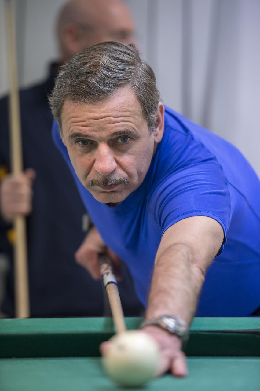 Expedition 43 Russian Cosmonaut Mikhail Kornienko of the Russian Federal Space Agency (Roscosmos) plays pool with NASA Astronaut Scott Kelly at the Cosmonaut Hotel, Thursday, March 19, 2015 in Baikonur, Kazakhstan. Kelly, Kornienko, and Russian Cosmonaut Gennady Padalka are preparing for launch to the International Space Station in their Soyuz TMA-16M spacecraft from the Baikonur Cosmodrome in Kazakhstan March 28, Kazakh time. As the one-year crew, Kelly and Kornienko will return to Earth on Soyuz TMA-18M in March 2016. Photo Credit: (NASA/Bill Ingalls)