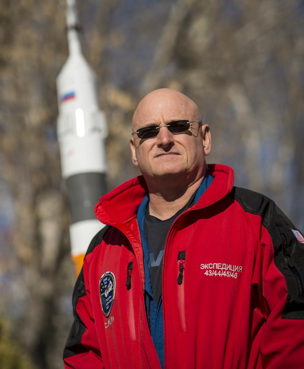 Expedition 43 NASA Astronaut Scott Kelly poses for a portrait near a model of the Soyuz rocket, Friday, March 20, 2015 at the Cosmonaut Hotel in Baikonur, Kazakhstan. Kelly, and Russian Cosmonauts Gennady Padalka, and Mikhail Kornienko of the Russian Federal Space Agency (Roscosmos) are preparing for launch to the International Space Station in their Soyuz TMA-16M spacecraft from the Baikonur Cosmodrome in Kazakhstan March 28, Kazakh time. As the one-year crew, Kelly and Kornienko will return to Earth on Soyuz TMA-18M in March 2016. Photo Credit: (NASA/Bill Ingalls)