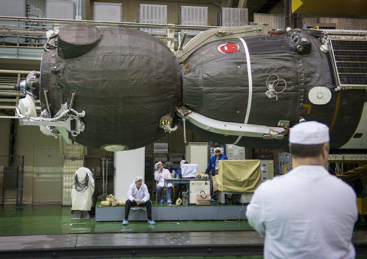 The Soyuz TMA-16M spacecraft is seen after being lowered into position for encapsulation with its fairing, Friday, March 20, 2015 at the Baikonur Cosmodrome in Kazakhstan. Expedition 43 NASA Astronaut Scott Kelly, and Russian Cosmonauts Gennady Padalka, and Mikhail Kornienko of the Russian Federal Space Agency (Roscosmos) are scheduled to launch to the International Space Station in the Soyuz TMA-16M spacecraft from the Baikonur Cosmodrome in Kazakhstan March 28, Kazakh time. As the one-year crew, Kelly and Kornienko will return to Earth on Soyuz TMA-18M in March 2016. Photo Credit: (NASA/Bill Ingalls)