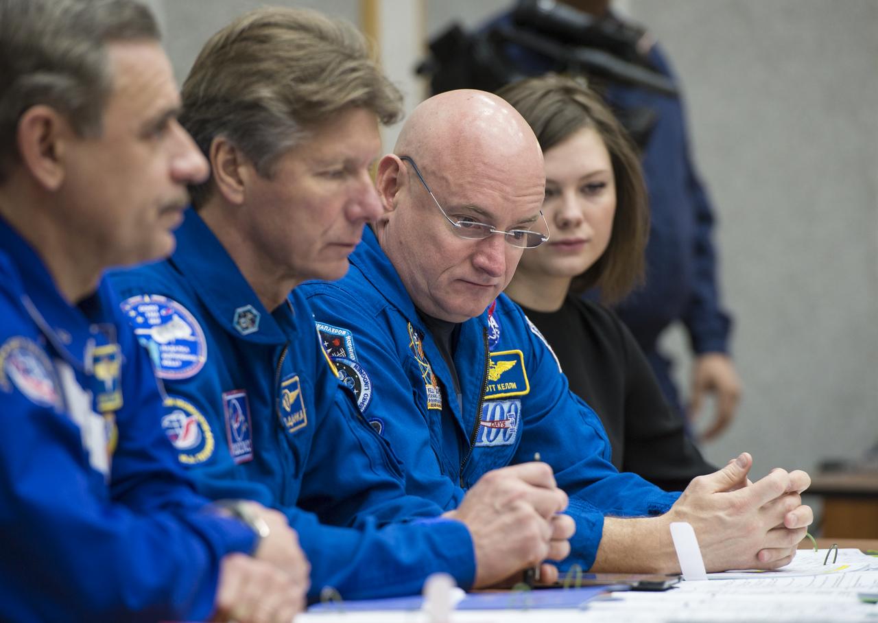 Expedition 43 Russian Cosmonauts Mikhail Kornienko, left, and Gennady Padalka of the Russian Federal Space Agency (Roscosmos), center, and NASA Astronaut Scott Kelly attend a briefing, Saturday, March 21, 2015 at the Cosmonaut Hotel in Baikonur, Kazakhstan. Kelly, Padalka, and Kornienko are preparing for launch to the International Space Station in their Soyuz TMA-16M spacecraft from the Baikonur Cosmodrome in Kazakhstan March 28, Kazakh time (March 27 Eastern time.) As the one-year crew, Kelly and Kornienko will return to Earth on Soyuz TMA-18M in March 2016. Photo Credit: (NASA/Bill Ingalls)
