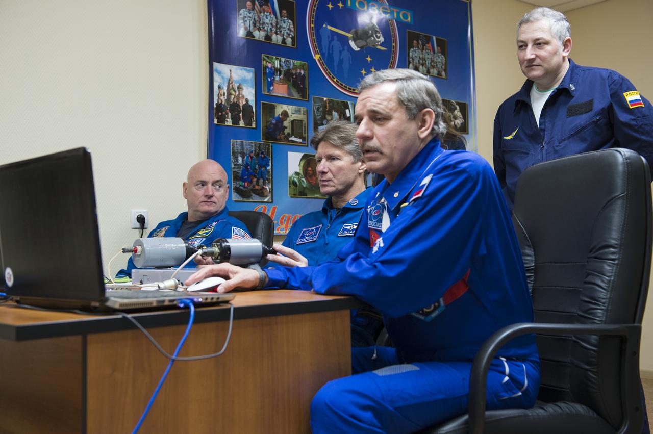 Expedition 43 NASA Astronaut Scott Kelly, seated left, Russian Cosmonauts Gennady Padalka, center, and Mikhail Kornienko of the Russian Federal Space Agency (Roscosmos), work on Soyuz training, Saturday, March 21, 2015 at the Cosmonaut Hotel in Baikonur, Kazakhstan. Kelly, Padalka, and Kornienko are preparing for launch to the International Space Station in their Soyuz TMA-16M spacecraft from the Baikonur Cosmodrome in Kazakhstan March 28, Kazakh time (March 27 Eastern time.) As the one-year crew, Kelly and Kornienko will return to Earth on Soyuz TMA-18M in March 2016. Photo Credit: (NASA/Bill Ingalls)