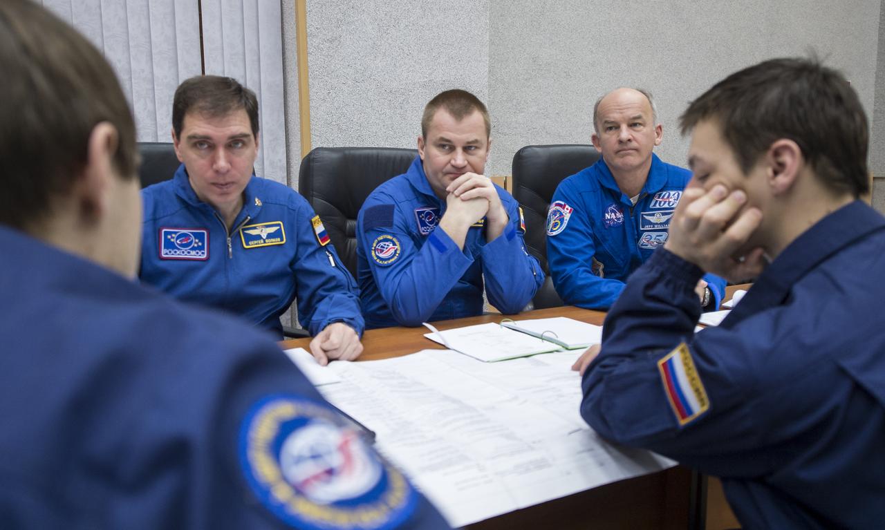 Expedition 43 backup crew members Sergei Volkov, left, and Alexey Ovchinin and of the Russian Federal Space Agency (Roscosmos), center, and NASA Astronaut Jeff Williams attend a training briefing, Saturday, March 21, 2015 at the Cosmonaut Hotel in Baikonur, Kazakhstan. Expedition 43 prime crew members: NASA Astronaut Scott Kelly, and Russian Cosmonauts Gennady Padalka, and Mikhail Kornienko of the Russian Federal Space Agency (Roscosmos) are scheduled to launch to the International Space Station in the Soyuz TMA-16M spacecraft from the Baikonur Cosmodrome in Kazakhstan March 28, Kazakh time (March 27 Eastern time.) As the one-year crew, Kelly and Kornienko will return to Earth on Soyuz TMA-18M in March 2016. Photo Credit: (NASA/Bill Ingalls)